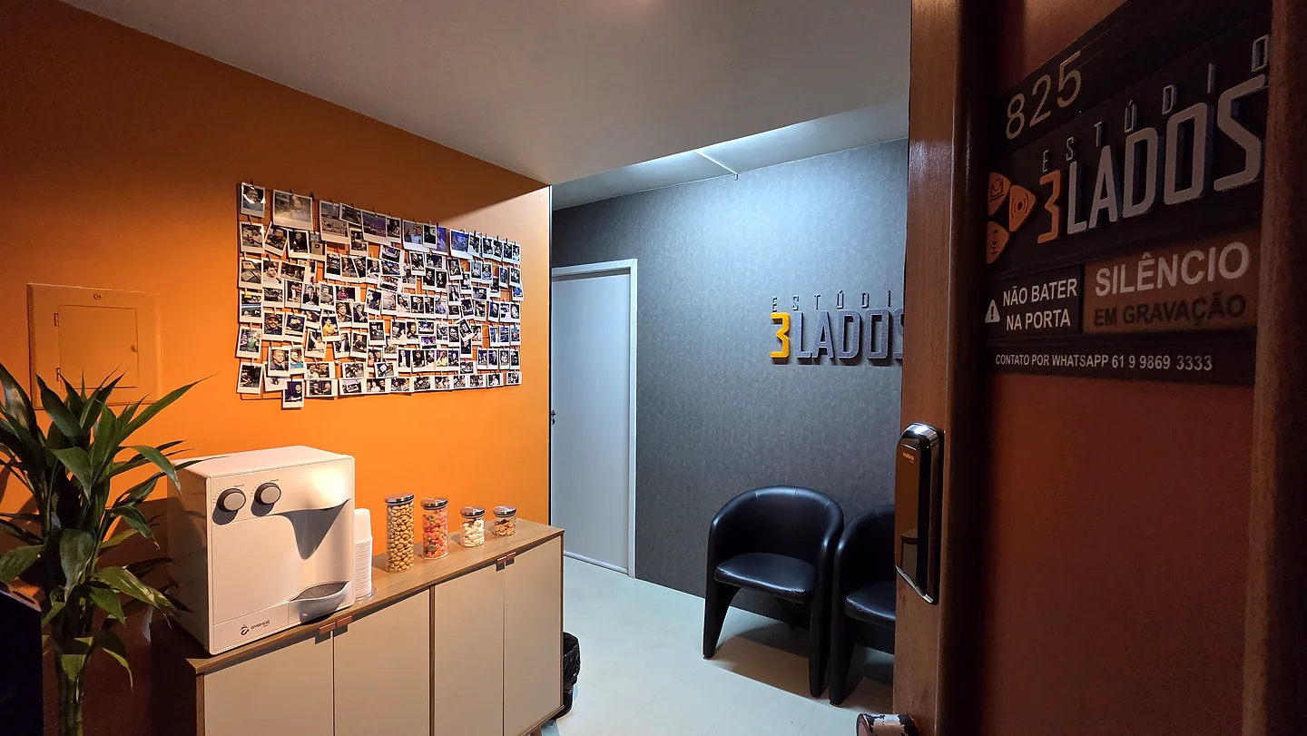 Recepção do Estúdio 3 LADOS com água, assentos e mural de clientes